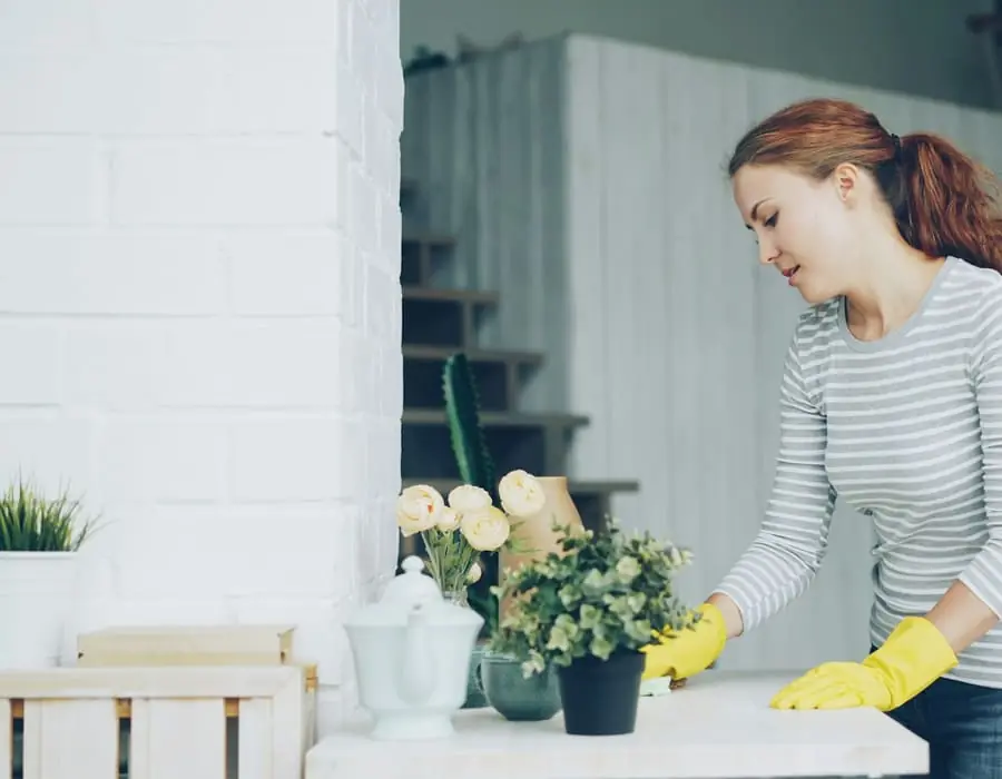 Housekeeper cleaning the floor in a bright new home